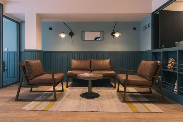 Two brown armchairs, sofa, round coffee table, living room at Picturehouse Apartments in Exeter Student Accommodation