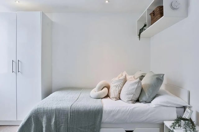 Bed with pillows wardrobe and shelf Bedroom at Picturehouse Apartments in Exeter Student Accommodation