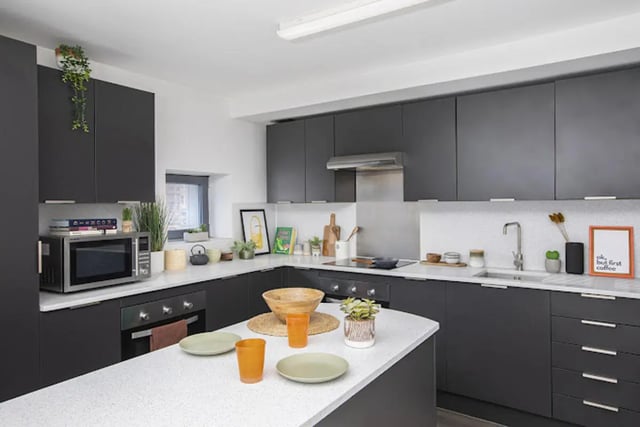 Modern dark kitchen island with plates and glasses kitchen at Lakeside in Birmingham Student Accommodation