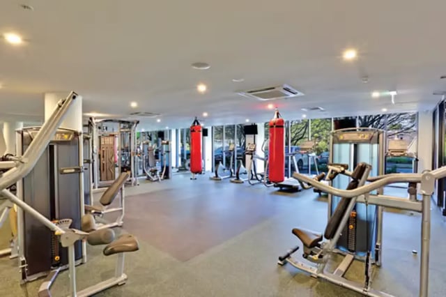 Gym equipment and red punching bags gym at Scape at University of Sydney in Sydney Student Accommodation