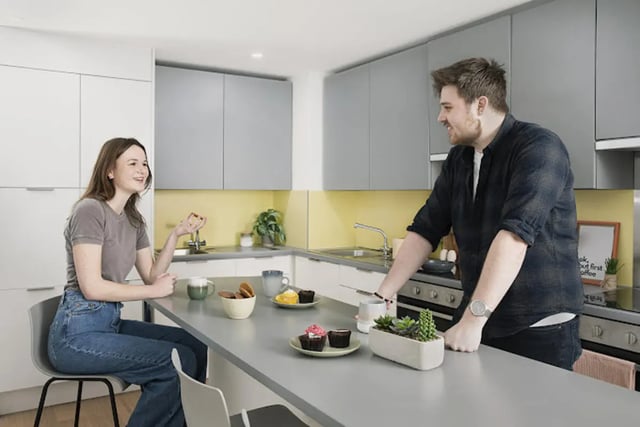 Couple talking in modern kitchen with cupcakes kitchen at Staniforth House in Birmingham Student Accommodation