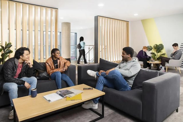 Students relaxing on sofas coffee table living room at Staniforth House in Birmingham Student Accommodation