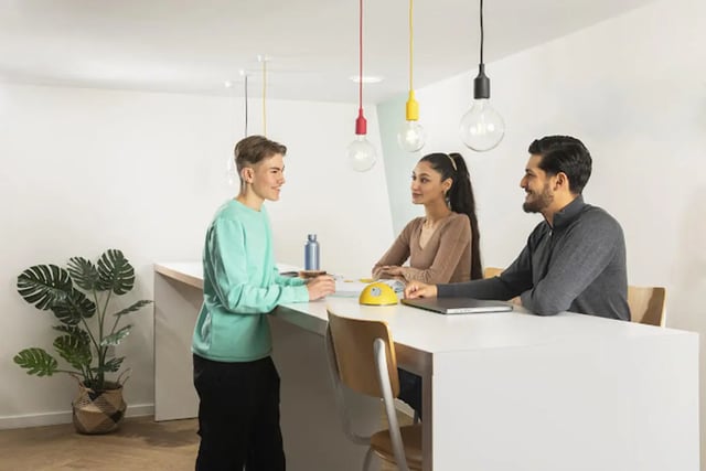 Three students talking at a counter study area at Staniforth House in Birmingham Student Accommodation