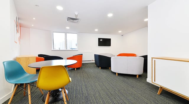 Colorful chairs round table lounge area living room at Miura in Nottingham Student Accommodation