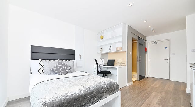 Bed desk and door of studio apartment at Miura in Nottingham Student Accommodation