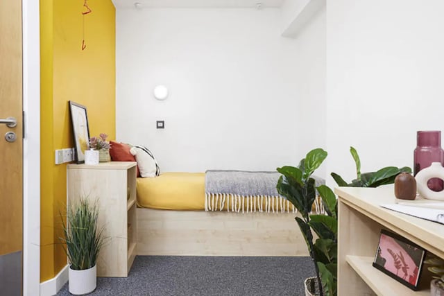 Bed with yellow bedding and grey blanket bedroom at Harriet Martineau in Birmingham Student Accommodation