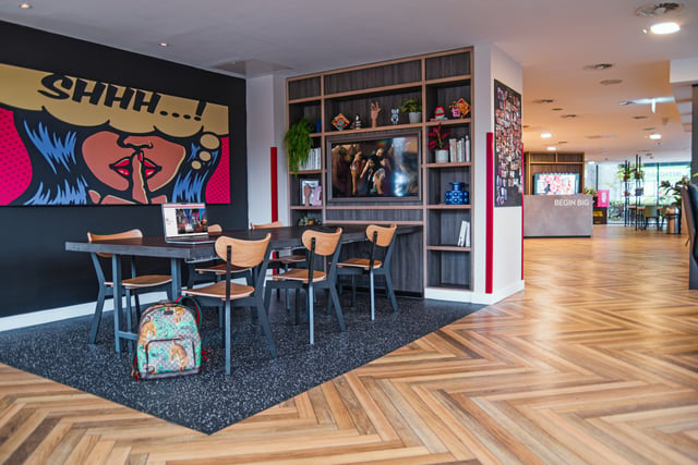 Table chairs backpack and pop art wall lounge at Vita Student Richmond House in Southampton Student Accommodation