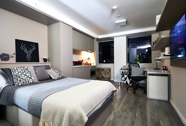 Bed kitchenette desk and tv studio apartment at Vita Student Richmond House in Southampton Student Accommodation