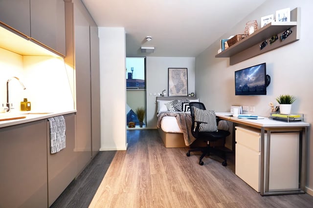 Kitchen counter bed desk and TV studio apartment at Vita Student Richmond House in Southampton Student Accommodation