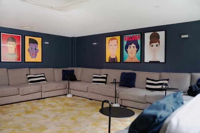 Large sectional sofa framed art yellow rug living room at Vita Student Richmond House in Southampton Student Accommodation
