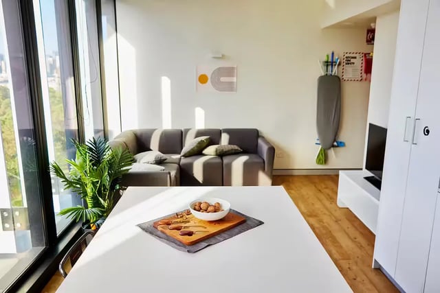 Table with walnuts couch with pillows living room at Scape Quay in Sydney Student Accommodation