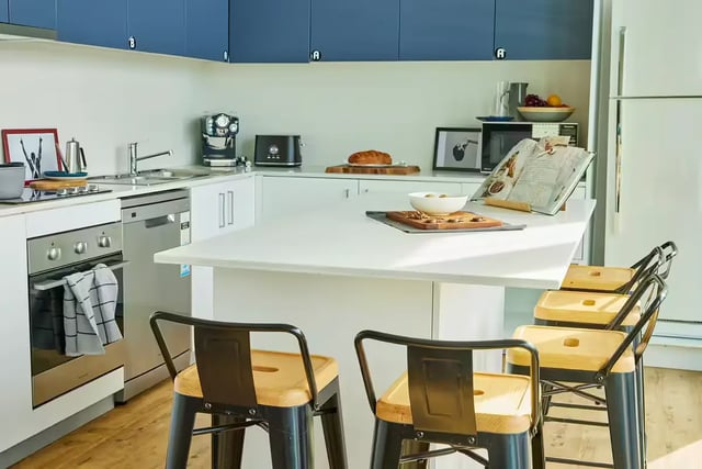 Modern student kitchen with island and bar stools kitchen at Scape Quay in Sydney Student Accommodation