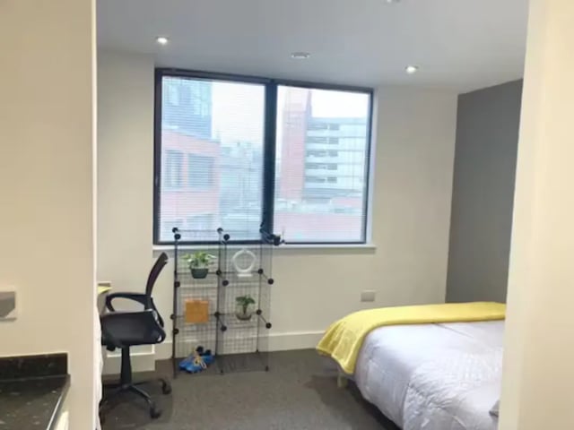 Bed desk shelf chair and window bedroom at Hydrogen in Nottingham Student Accommodation