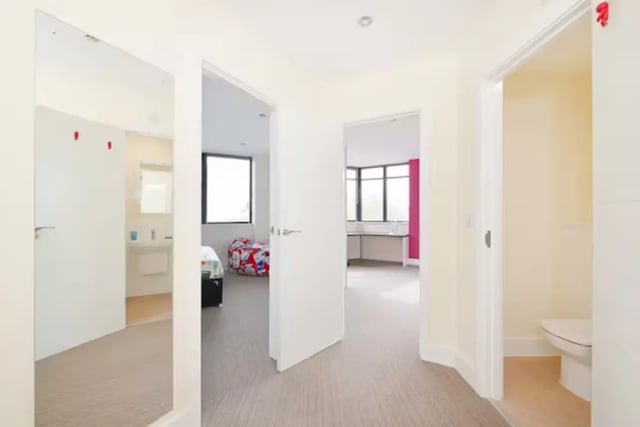 Hallway with doors leading to bedroom bathroom and kitchen area at Hydrogen in Nottingham Student Accommodation