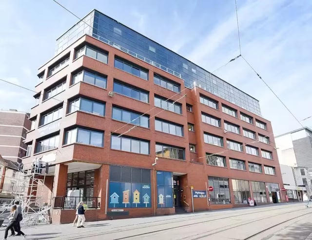 Red brick building with modern glass top exterior at Hydrogen in Nottingham Student Accommodation