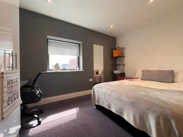 Bed desk chair and shelves bedroom at Hydrogen in Nottingham Student Accommodation