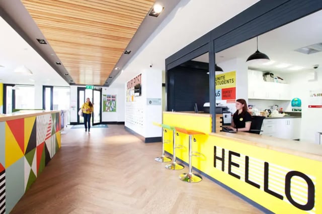 Reception area with colorful counter and staff reception area at Dorset House in Oxford Student Accommodation