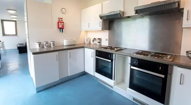 White kitchen with toaster and two ovens kitchen at East Shore in St Andrews Student Accommodation