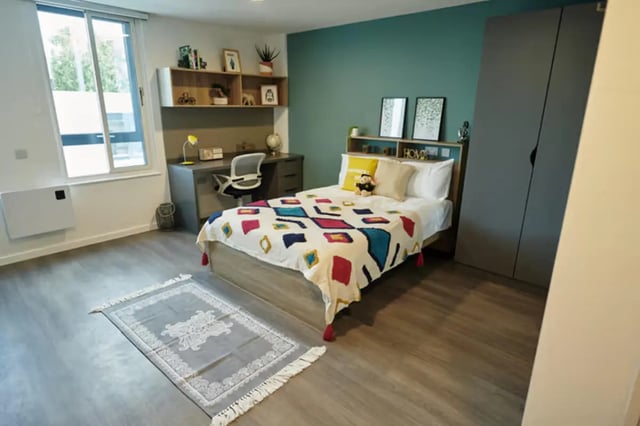 Bed desk shelves closet rug bedroom at The Old Fire Station - Birmingham in Birmingham Student Accommodation