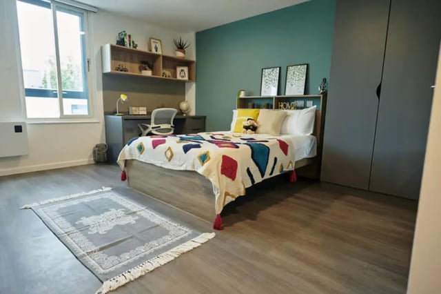 Bed desk chair rug and wardrobe bedroom at The Old Fire Station - Birmingham in Birmingham Student Accommodation