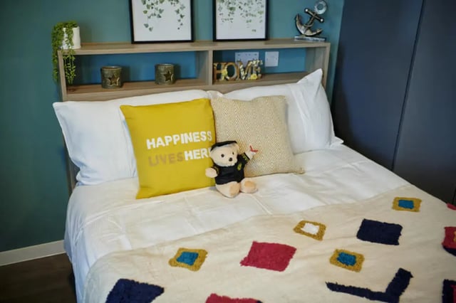 Bed with yellow pillow and teddy bear bedroom at The Old Fire Station - Birmingham in Birmingham Student Accommodation