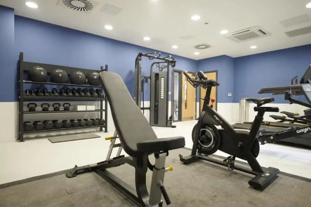 Weight bench exercise bikes and treadmills fitness room at The Old Fire Station - Birmingham in Birmingham Student Accommodation