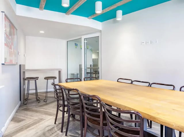 Large table and chairs with bar stools study area at Mercury House in Bournemouth Student Accommodation
