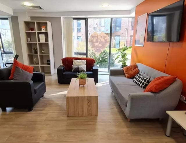 Sofa bookshelf coffee table living room at Tramways in Chester Student Accommodation