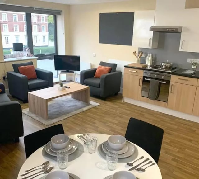Sofas coffee table TV kitchen dining table living room at Tramways in Chester Student Accommodation