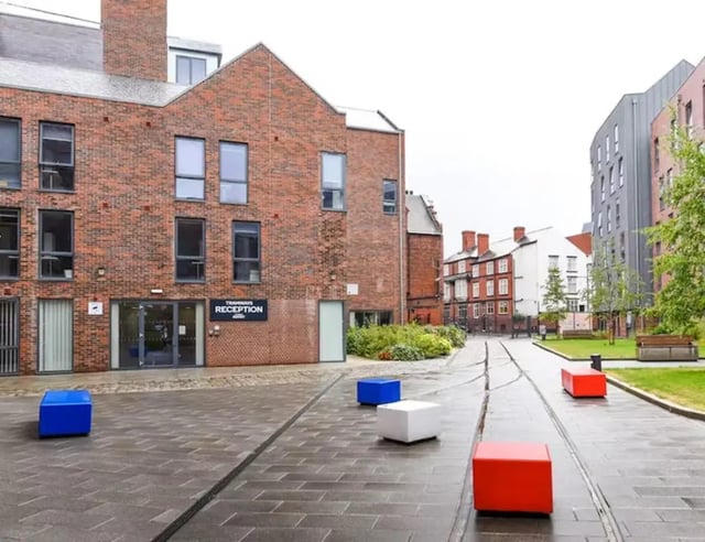 Brick building with reception and colorful outdoor seating exterior at Tramways in Chester Student Accommodation