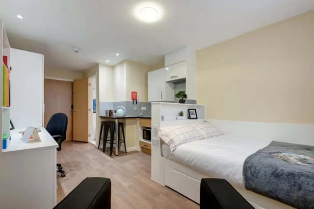 Bed desk kitchen and stools student studio. at Llys Y Deon in Bangor Student Accommodation