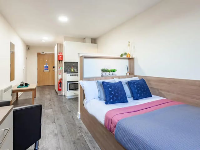 Bed kitchen area and desk student studio at Neuadd Kyffin in Bangor Student Accommodation