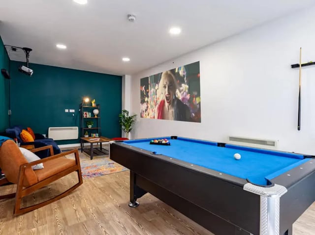 Pool table projector screen sofa and chair lounge at Neuadd Kyffin in Bangor Student Accommodation