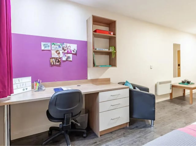 Desk chair photos on purple wall study area at Neuadd Kyffin in Bangor Student Accommodation