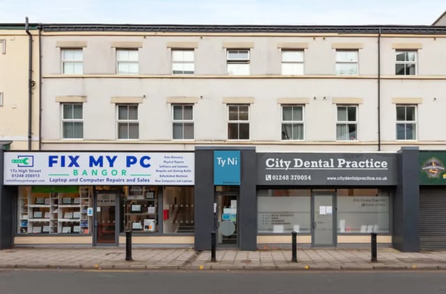 Commercial building facade with shops below and apartments above Exterior at Ty Ni in Bangor Student Accommodation