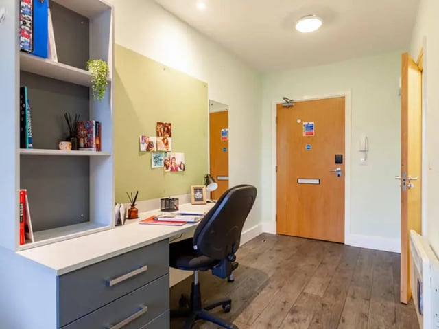 Desk with chair and shelves study area at Ty Ni in Bangor Student Accommodation