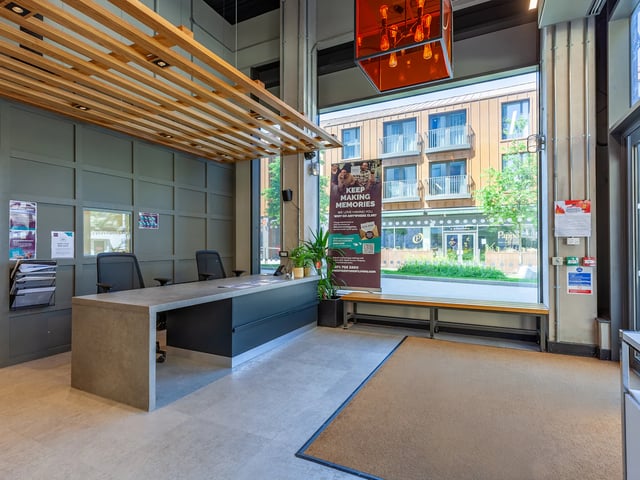Reception desk with chairs and window view reception area at West Way Square in Oxford Student Accommodation