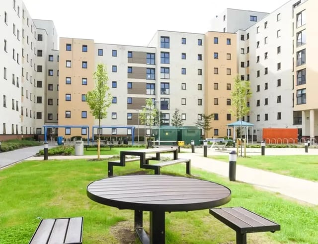 Picnic tables on grassy courtyard exterior at St Davids in Swansea Student Accommodation