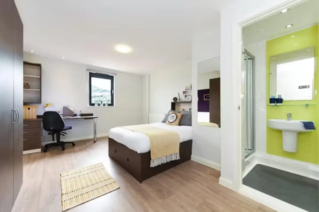 Bedroom with bed desk and bathroom interior at St Davids in Swansea Student Accommodation