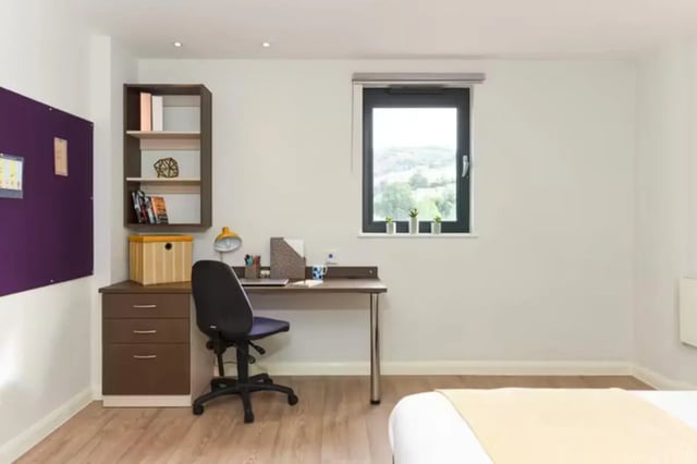 Desk chair shelves window and bed bedroom at St Davids in Swansea Student Accommodation