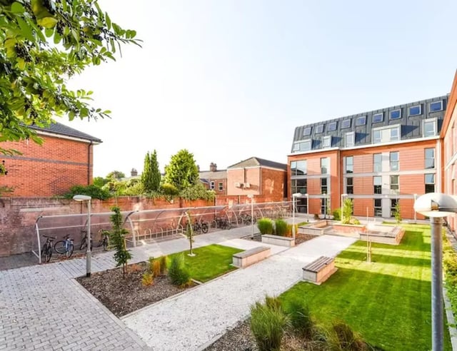 Bike racks green lawn benches student accommodation exterior at The Boulevard in York Student Accommodation