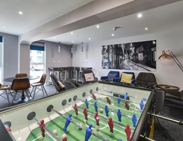 Foosball table with chairs and artwork Common Area at The Boulevard in York Student Accommodation