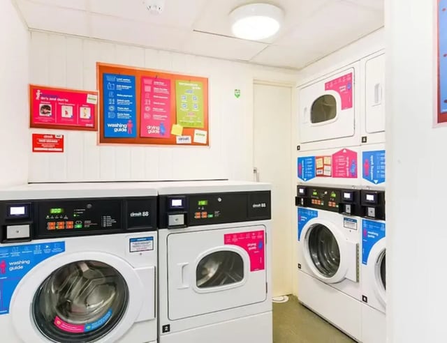 Washing machines dryers notice board laundry area at The Boulevard in York Student Accommodation
