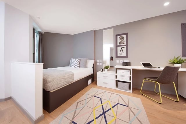 Bed desk storage unit and patterned rug bedroom at Horizon Heights in Liverpool Student Accommodation