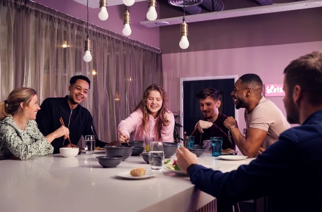 Students eating at a table communal dining area at Horizon Heights in Liverpool Student Accommodation