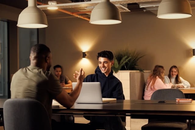 Students collaborate around a laptop study area at Horizon Heights in Liverpool Student Accommodation