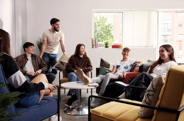 Students chatting in a communal living room at Atlantic Point in Liverpool Student Accommodation
