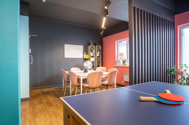 Dining table with pink chairs whiteboard ping pong table at St Augustine's House in Plymouth Student Accommodation