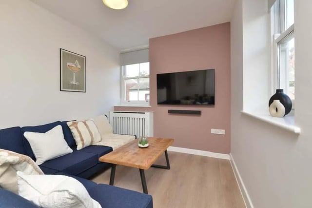 Blue sofa coffee table television and artwork Living room at Isca Lofts in Exeter Student Accommodation