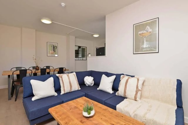 Blue sectional couch wooden table coffee art Living Room at Isca Lofts in Exeter Student Accommodation